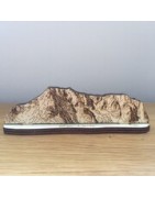 Hand drawn mountains cut from wood.
